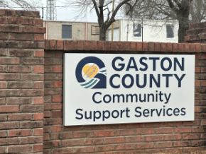 A sign that says gaston county community support services.