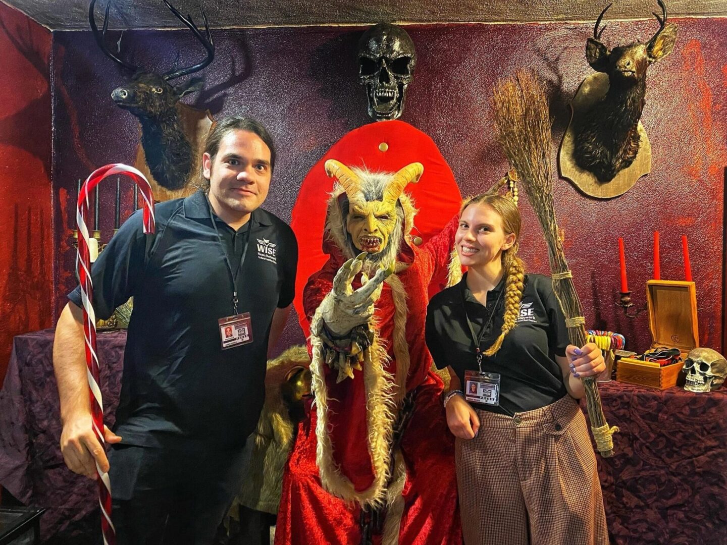 A man and two women posing with an animal costume.