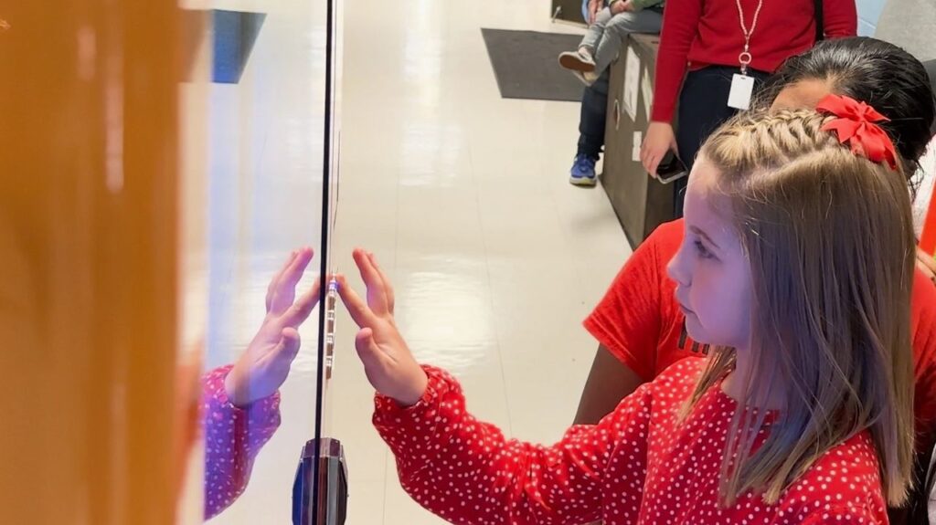 A student trying out the vending machine meant to help with student literacy.