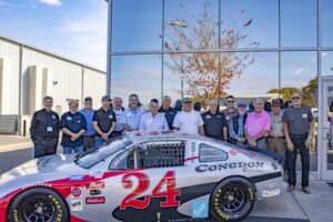 The attendees of the Dash Series Reunion who were drivers, posing for a photo in front of Hendrick Motorsports.