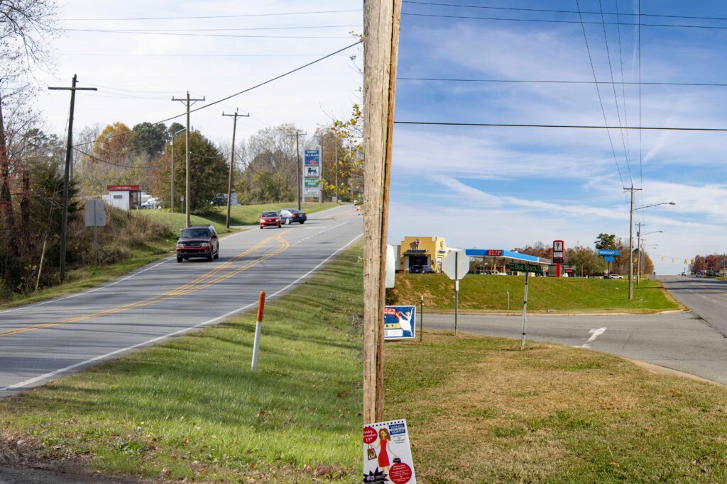 Two different stretches of road both ending at a grocery store sign. 