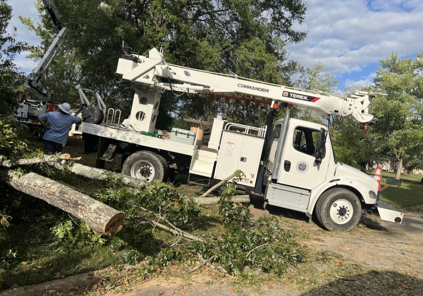 a City of CHerryville Work Truck clearing downed trees.