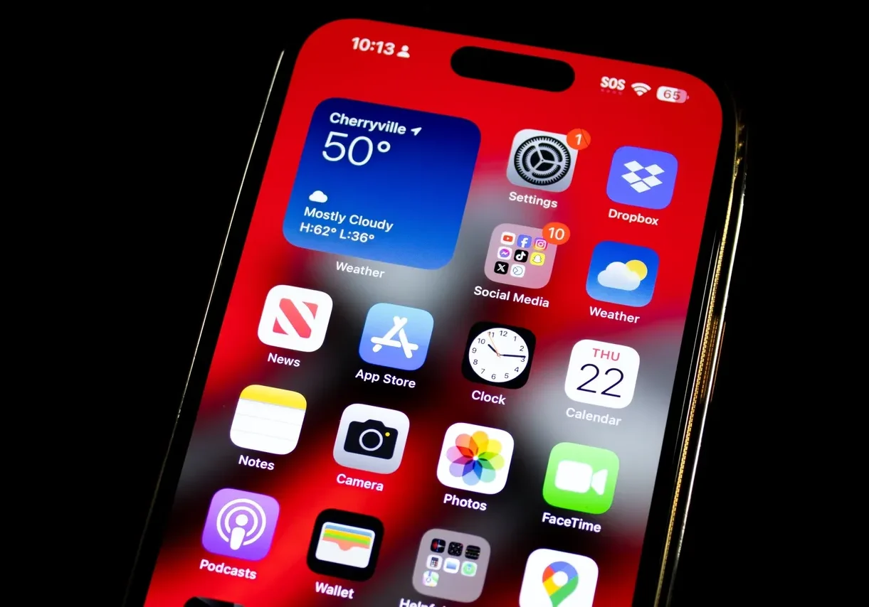 A close up of an iphone with the home screen showing.